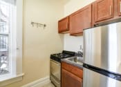 Thumbnail 12 of 35 - kitchen with stainless steel appliances and large window at dupont apartments in washington dc