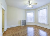 Thumbnail 20 of 35 - vacant living area with hardwood floors, large windows and ceiling fan at dupont apartments in washington dc