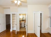Thumbnail 22 of 35 - vacant bedroom with large windows, closet, ceiling fan and view of bathroom at dupont apartments in washington dc