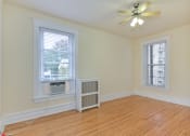 Thumbnail 19 of 35 - vacant bedroom with hardwood flooring, large windows, and ceiling fan at dupont apartments in washington dc