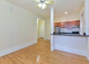 Thumbnail 14 of 35 - vacant living area with hardwood floors, view of kitchen and ceiling fan at dupont apartments in washington dc