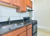 Thumbnail 2 of 35 - kitchen with granite countertops, tile backsplash and large windows at dupont apartments in washington dc