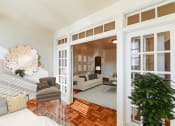 Thumbnail 9 of 20 - living area with sofa, coffee table, hardwood floors and view of sunroom at eddystone apartments in washington dc