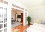 Thumbnail 10 of 20 - living area with sofa, coffee table, hardwood floors and view of sunroom at eddystone apartments in washington dc