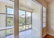 Thumbnail 8 of 29 - vacant sunroom with large windows and tile flooring at the frontenac apartments in van ness washington dc