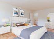 Thumbnail 12 of 19 - bedroom with bed, nightstands, dresser, mirror and hardwood flooring at fort totten apartments in washington dc