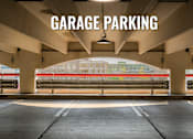 Thumbnail 24 of 26 - Garage parking with a view of a building in the background.