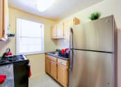 Thumbnail 2 of 15 - Garden Village tax credit Renovated Kitchen with stainless steel appliances and oak cabinetry in congress heights washington dc