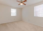 Thumbnail 5 of 16 - living area with carpeting and ceiling fan at grandview village apartments in shipley terrace washington dc