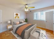 Thumbnail 4 of 13 - a bedroom with a bed and a ceiling fan at halley house apartments in washington dc