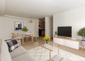 Thumbnail 8 of 13 - a living room with a couch and a table and a television at halley house apartments in washington dc