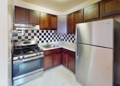 Thumbnail 2 of 13 - a kitchen with stainless steel appliances and wooden cabinets