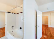 Thumbnail 10 of 25 - bathroom with tub and views of bedroom and living areas at hampton courts apartments in washington dc