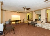 Thumbnail 17 of 25 - a living room filled with furniture and a ceiling fan