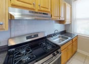 Thumbnail 13 of 25 - kitchen at hampton courts apartments in dc with stainless steel appliances