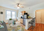 Thumbnail 5 of 25 - a living room with a kitchen and a ceiling fan