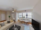 Thumbnail 2 of 19 - living area with sofa coffee table and view of dining area with large windows at hilltop house in columbia heights washington dc
