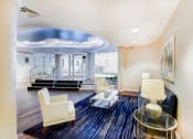 Thumbnail 11 of 19 - front entrance lobby lounge with social seating, view of front entrance and modern artwork  at hilltop house apartments in columbia heights washington dc
