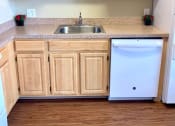 Thumbnail 6 of 18 - kitchen with oak cabinetry and dish washer at 3101 Pennsylvania apartments in Washington dc