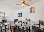 Thumbnail 8 of 25 - A dining room with a glass table and chairs.