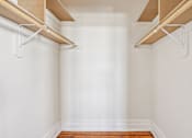 Thumbnail 9 of 32 - A white wall with a wooden shelf on top.