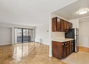 Thumbnail 19 of 36 - A kitchen with wooden cabinets and a refrigerator.
