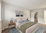 Thumbnail 4 of 43 - A bedroom with a bed, nightstand, and two pictures on the wall.