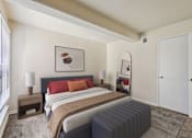 Thumbnail 7 of 43 - A bedroom with a bed, nightstands, and a painting on the wall.