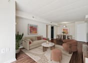 Thumbnail 6 of 43 - A living room with a couch, chairs, and a coffee table.