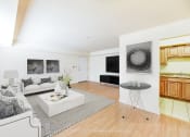 Thumbnail 5 of 14 - living area with sofa, coffee table, view of kitchen, tv, and hardwood flooring at jasper place apartments in washington dc