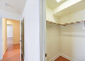 Thumbnail 12 of 14 - hallway view of walk in closet and living area with wood flooring at jasper place apartments in congress heights washington dc