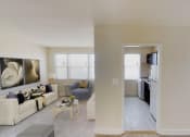 Thumbnail 8 of 16 - living area with sofa, coffee table, credenza, plush carpeting, and large windows at jetu apartments in washington dc