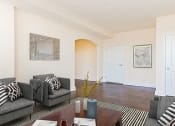 Thumbnail 7 of 21 - living area with sofa, coffee table, coat closet and hardwood floors at juniper courts apartments in takoma washington dc