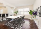 Thumbnail 6 of 21 - dining area with table, chairs, large windows, and view of kitchen with breakfast bar at juniper courts apartments