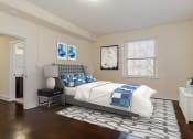 Thumbnail 10 of 21 - bedroom with bed, nightstands, dresser and large windows at juniper courts apartments in washington dc