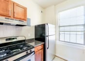 Thumbnail 14 of 29 - kitchen with stainless steel appliances, tile backsplash and window at the frontenac apartments in van ness washington dc
