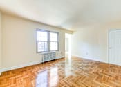 Thumbnail 12 of 22 - vacant living area with hardwood flooring and large windows at richman apartments in washington dc