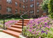Thumbnail 23 of 33 - courtyard with table, chairs, grilling area and lush landscaping at meridian park apartments in washington dc