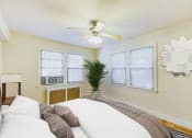 Thumbnail 8 of 33 - bedroom with bed, large windows, hardwood flooring and ceiling fan at meridian park apartments in washington dc