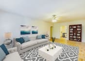 Thumbnail 7 of 33 - living area with seating area, coffee table, bookshelf, hardwood flooring and ceiling fan at meridian park apartments in washington dc