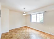 Thumbnail 11 of 24 - vacant dining area with lighting, wood floors and large window at naylor overlook apartments in skyland washington dc