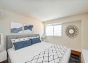 Thumbnail 5 of 24 - bedroom with bed, nightstand, hardwood flooring and window at naylor overlook apartments in washington dc