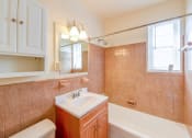 Thumbnail 11 of 15 - bathroom with tub, vanity, large mirror and tile details at new horizon apartments in washington dc