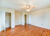 Thumbnail 13 of 15 - vacant bedroom with hardwood floors, ceiling fan, and large closet at new horizon apartments in washington dc