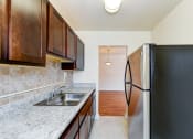 Thumbnail 2 of 15 - kitchen with espresso cabinetry and stainless steel appliances at new horizon apartments in washington dc