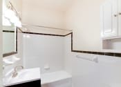 Thumbnail 14 of 28 - bathroom with sink, mirror, cabinet, tub and tile details at norwood apartments in washington dc