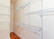 Thumbnail 13 of 28 - closet with custom shelving and hardwood floors at norwood apartments in washington dc