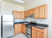 Thumbnail 10 of 28 - kitchen with stainless steel appliances and wood cabinetry at norwood apartments in washington dc