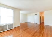 Thumbnail 12 of 28 - vacant living area with hardwood flooring and large windows at norwood apartments in washington dc