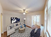 Thumbnail 6 of 29 - living area with large windows, sofa, coffee table, hardwood floors, and ceiling fan at parkside apartments in washington dc
